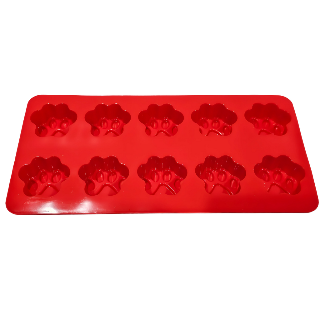 Red silicone mold with paw print shapes on a white background