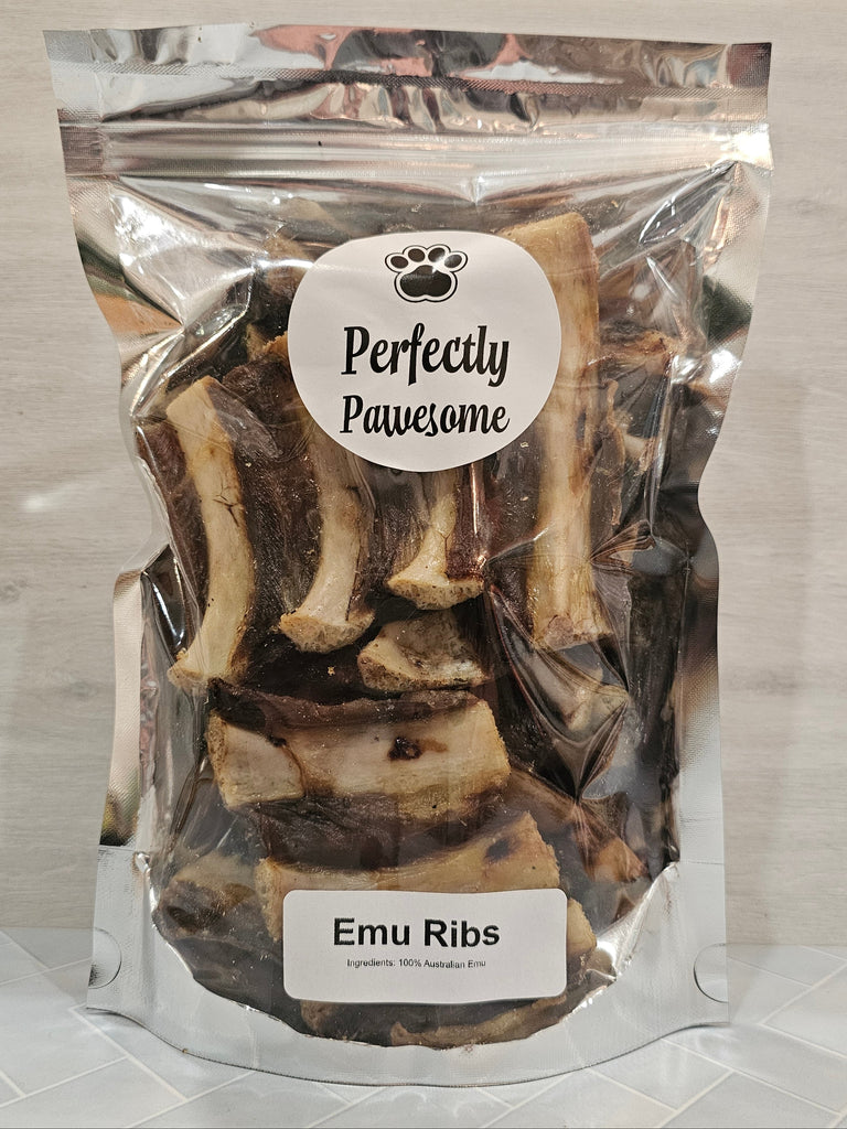 Package of dehydrated emu ribs dog snacks with 'Perfectly Pawesome' label on a decorative white background