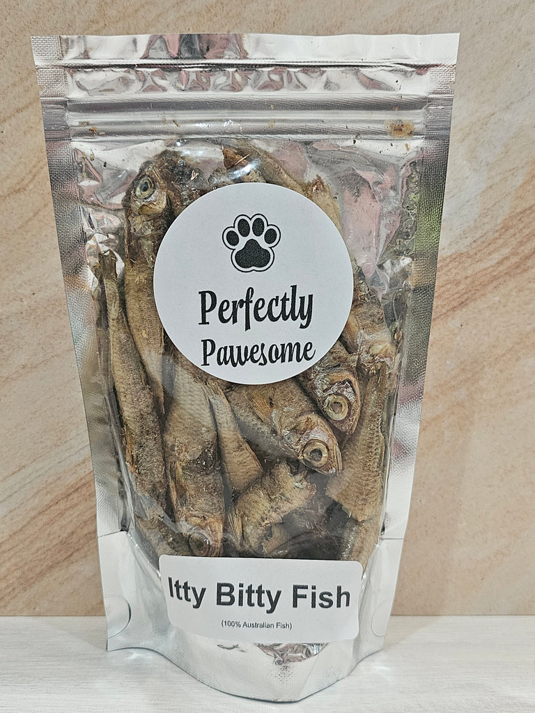 Package of dried fish labeled 'Perfectly Pawesome' on a wooden surface