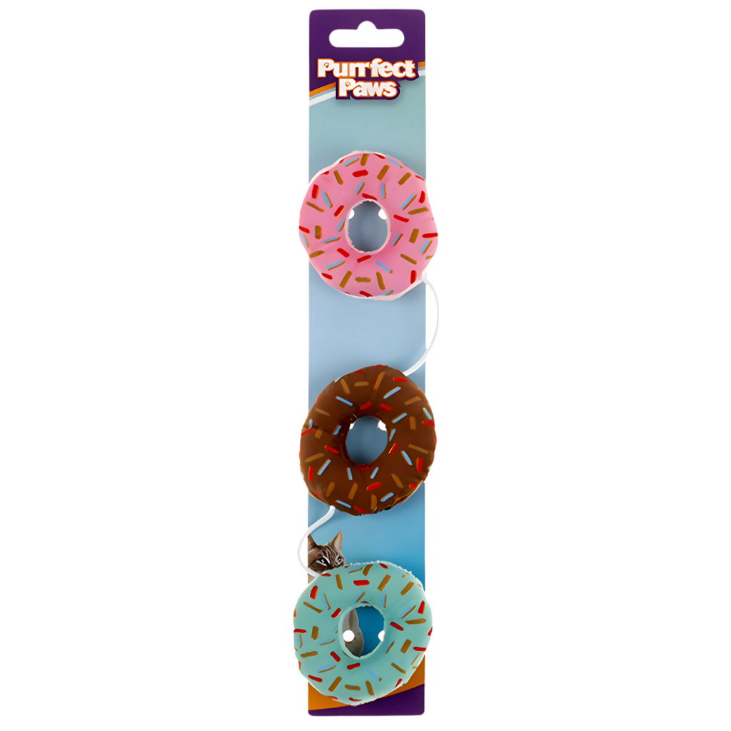 Three donut-shaped pet toys with colorful sprinkles on a 'Purrfect Paws' branded card.