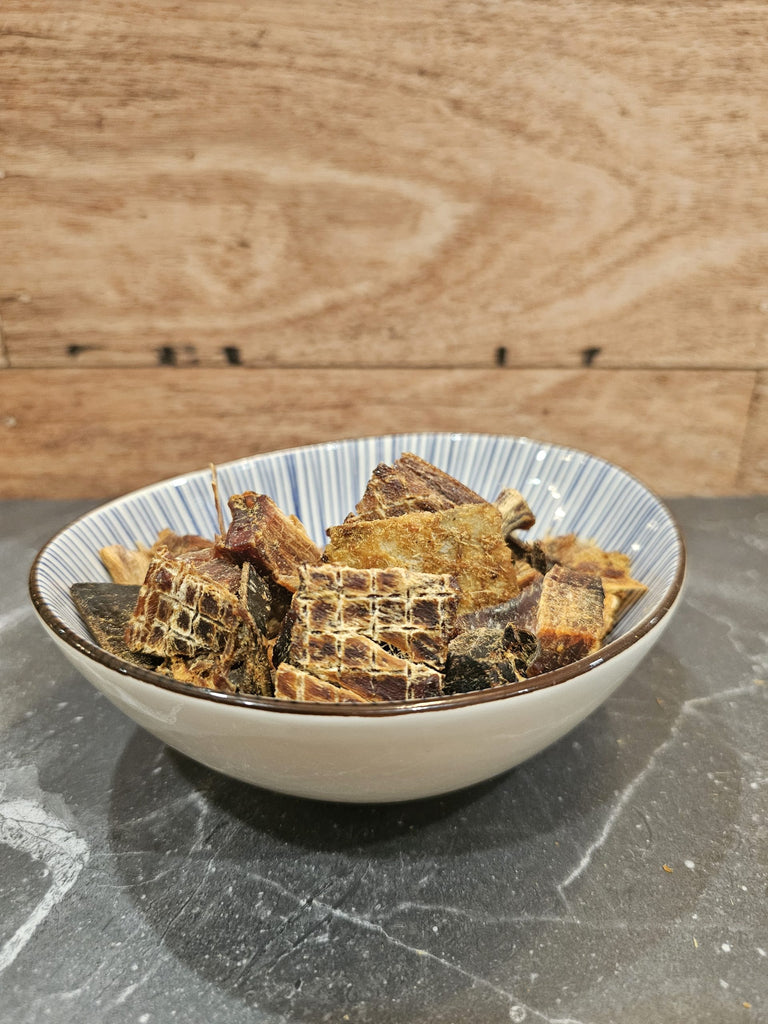 stylised picture of dried fish tuna jerky in bowl on decorative background