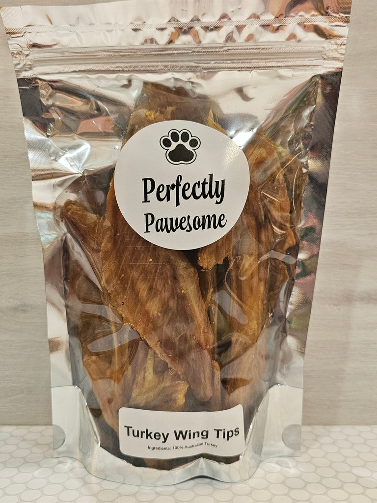 Package of turkey wing tips with 'Perfectly Pawesome' label on a textured surface